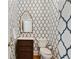 Stylish powder room with decorative wallpaper, mirror, and modern fixtures at 5602 Asheforde Ln, Marietta, GA 30068