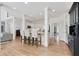 Open concept kitchen features hardwood floors, white cabinets, bar stool seating and black accent cabinets at 5602 Asheforde Ln, Marietta, GA 30068