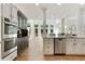 Bright kitchen features stainless steel appliances, white and black cabinetry, and an open floorplan at 5602 Asheforde Ln, Marietta, GA 30068