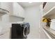 Modern laundry room featuring front-load washer and dryer plus ample storage at 5602 Asheforde Ln, Marietta, GA 30068