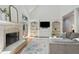 Comfortable living room features a fireplace, built-in shelving, and a vaulted ceiling at 5602 Asheforde Ln, Marietta, GA 30068