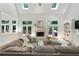 Living room boasts soaring ceilings, a fireplace, built-in shelving, and lots of natural light at 5602 Asheforde Ln, Marietta, GA 30068