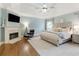 Spacious primary bedroom with fireplace, sitting area, and tray ceiling at 5602 Asheforde Ln, Marietta, GA 30068
