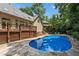 A sparkling pool complements a spacious stone patio and a large deck, creating an ideal setting for summer enjoyment at 5602 Asheforde Ln, Marietta, GA 30068
