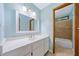 Bathroom features a single sink vanity with a mirror and a tiled shower at 766 Lost Creek Cir, Stone Mountain, GA 30088