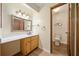 Bright bathroom featuring a vanity with a sink, decorative mirror, and toilet at 766 Lost Creek Cir, Stone Mountain, GA 30088