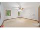 Bright bedroom features multiple windows, neutral carpet, and a ceiling fan at 766 Lost Creek Cir, Stone Mountain, GA 30088
