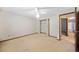 Bedroom with a closet, ceiling fan, neutral carpet, and access to hallway at 766 Lost Creek Cir, Stone Mountain, GA 30088