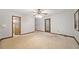 Spacious bedroom with neutral carpeting, ceiling fan, and sliding glass door at 766 Lost Creek Cir, Stone Mountain, GA 30088