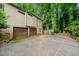 Spacious driveway leading to a two-car garage surrounded by lush trees at 766 Lost Creek Cir, Stone Mountain, GA 30088