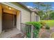 Welcoming entryway with a wooden porch, mature shrubs, and a solid front door at 766 Lost Creek Cir, Stone Mountain, GA 30088