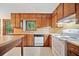 Kitchen featuring natural wood cabinets, and modern appliances, creating a warm and inviting space at 766 Lost Creek Cir, Stone Mountain, GA 30088
