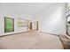 Open living space with a stone fireplace, carpet flooring, and large windows at 766 Lost Creek Cir, Stone Mountain, GA 30088