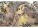 Drone shot showcasing the house, long driveway, surrounding landscape, and bordering creek at 1036 Wooten Lake Nw Rd, Kennesaw, GA 30144