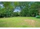 Large backyard with lawn, mature trees and landscaping at 130 Sunnybrook Ln, Woodstock, GA 30188