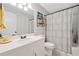 Clean bathroom featuring a vanity, commode, and shower with a decorative curtain at 130 Sunnybrook Ln, Woodstock, GA 30188