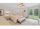 A Primary bedroom with a light color scheme and French doors to the outside at 130 Sunnybrook Ln, Woodstock, GA 30188