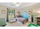 A bedroom with mountain mural, a single bed, and ample toy storage at 130 Sunnybrook Ln, Woodstock, GA 30188
