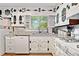 Updated kitchen features granite counters, white cabinetry, and modern fixtures at 130 Sunnybrook Ln, Woodstock, GA 30188