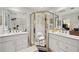 Bright bathroom with double sinks, tiled shower, and spacious layout at 1487 W Bend Creek Ct, Atlanta, GA 30338
