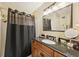 Bathroom with black granite vanity top, shower, and large framed mirror at 1487 W Bend Creek Ct, Atlanta, GA 30338