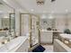 Luxurious bathroom featuring a glass shower enclosure, double sinks, and soaking tub at 1487 W Bend Creek Ct, Atlanta, GA 30338