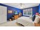 Blue bedroom featuring a bed, window with valance, and dresser with decor for a cozy feel at 1487 W Bend Creek Ct, Atlanta, GA 30338