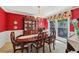 Formal dining room with a large window and red accent wall at 1487 W Bend Creek Ct, Atlanta, GA 30338