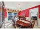Elegant dining room featuring rich colors, a chandelier, and large window views at 1487 W Bend Creek Ct, Atlanta, GA 30338