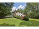 Beautiful backyard featuring a well-maintained lawn, a deck, and mature trees at 1487 W Bend Creek Ct, Atlanta, GA 30338