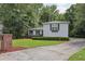 View of light gray house, green lawn, and long driveway at 1487 W Bend Creek Ct, Atlanta, GA 30338