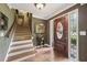 Elegant foyer with hardwood floors, staircase, and decorative front door at 1487 W Bend Creek Ct, Atlanta, GA 30338