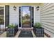 Home's front entrance features a glass door, sconces, and planters at 1487 W Bend Creek Ct, Atlanta, GA 30338