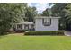 Charming single-Gathering home features lush lawn, manicured shrubs, and light gray siding at 1487 W Bend Creek Ct, Atlanta, GA 30338