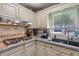 Modern kitchen with granite countertops, gas range, and stainless steel sink at 1487 W Bend Creek Ct, Atlanta, GA 30338