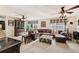 Spacious living room with a large leather sofa, ceiling fans, and natural light at 1487 W Bend Creek Ct, Atlanta, GA 30338