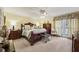 Spacious main bedroom with a ceiling fan, traditional furniture, and natural light at 1487 W Bend Creek Ct, Atlanta, GA 30338
