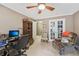 Cozy office space with a ceiling fan, beige walls, and a comfortable recliner for relaxation at 1487 W Bend Creek Ct, Atlanta, GA 30338