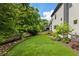 An expansive backyard features lush green grass and meticulous landscaping for outdoor enjoyment at 3233 Osborne Ne Rd, Brookhaven, GA 30319