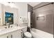 Modern bathroom with gray tiled shower, white vanity, and black fixtures at 3233 Osborne Ne Rd, Brookhaven, GA 30319