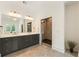 Bright primary bathroom with double vanity, glass enclosed shower, and neutral tile flooring at 3233 Osborne Ne Rd, Brookhaven, GA 30319