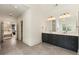 Bright bathroom with double vanity and marble counters that leads into main bedroom and walk-in closet at 3233 Osborne Ne Rd, Brookhaven, GA 30319