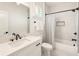 Clean, bright bathroom with marble tile, black fixtures, and a shower-tub combination at 3233 Osborne Ne Rd, Brookhaven, GA 30319