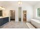 Bright primary bathroom with double vanity, shower, soaking tub, walk in closet, and neutral accents at 3233 Osborne Ne Rd, Brookhaven, GA 30319