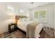 Bedroom with hardwood floors, large windows, and plush bed at 3233 Osborne Ne Rd, Brookhaven, GA 30319