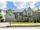 Beautiful two story traditional gray home with a two car garage, green grass, and lovely landscaping at 3233 Osborne Ne Rd, Brookhaven, GA 30319