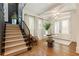 Foyer with staircase, hardwood floors, and modern light fixture at 3233 Osborne Ne Rd, Brookhaven, GA 30319