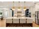 Bright and airy kitchen with a large center island, pendant lighting, and modern stainless steel appliances at 3233 Osborne Ne Rd, Brookhaven, GA 30319