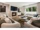 Open-concept living room featuring a fireplace, large windows, and comfortable seating at 3233 Osborne Ne Rd, Brookhaven, GA 30319