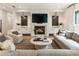 Beautiful living room with fireplace, large screen tv, and modern furnishings at 3233 Osborne Ne Rd, Brookhaven, GA 30319